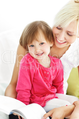 Smiling mother reading a book with children