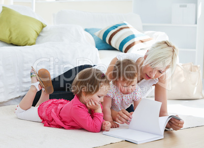 Mother reading a book with children