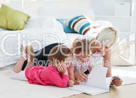 Mother reading a book with children