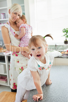 Attractive woman playing with her daughters