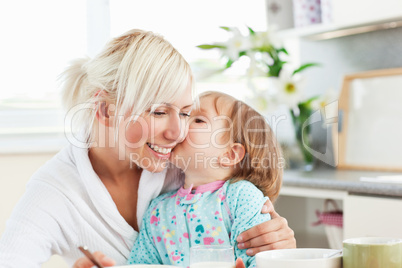 Simper mother and daughter having breakfast