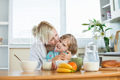 Mother and small daughter having breakfast