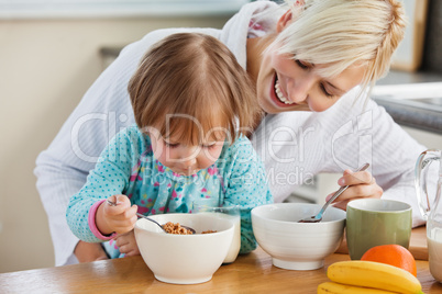 Mother and daughter having breakfast