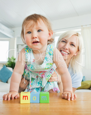 Radiant mother playing with her daughter