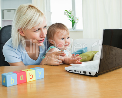 Young mother playing with her daughter