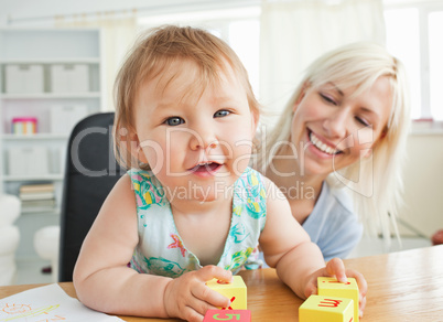 Glad mother playing with her daughter