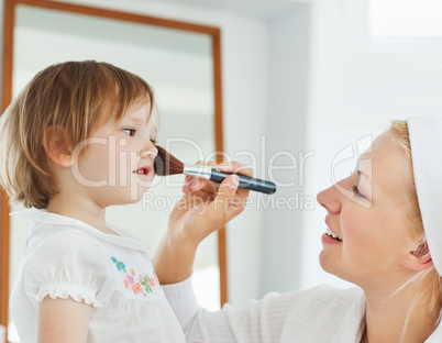 Young mother playing with her daughter