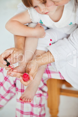 Mother making her daughter's nails
