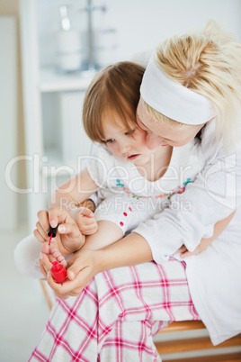 Concentrated mother playing with her daughter