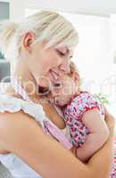 Smiling mother playing with her daughter