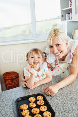 Smiling girl eating cookie
