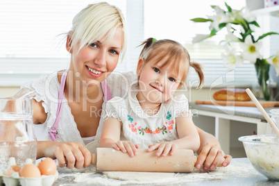 Kind mother and child baking cookies