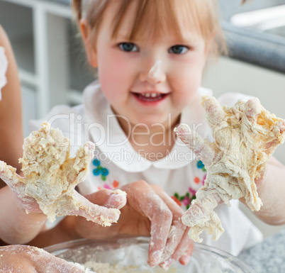 Sweet child baking cookies with hands