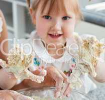 Sweet child baking cookies with hands