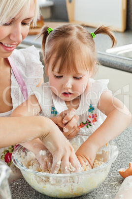 Happy mother and child baking cookies