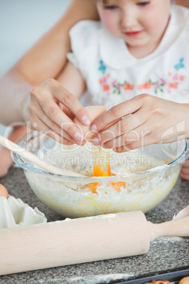 Mother and small child baking cookies