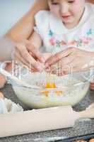 Mother and small child baking cookies