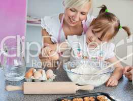 Young mother and child baking cookies