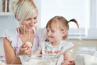 Smiling Mother and child baking cookies