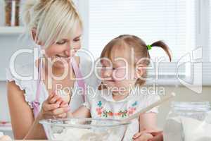 Smiling Mother and child baking cookies