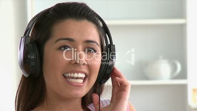 Radiant asian young woman listen to music with headphones on the