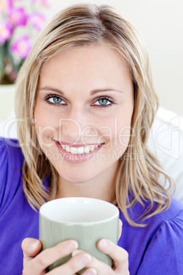 Glowing woman holding cup