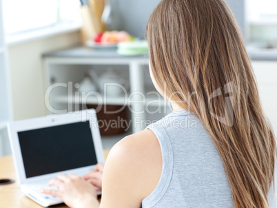 Attractive woman sitting in front of her laptop
