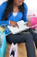 Busy woman using a laptop sitting on bed