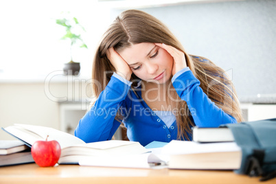 Young girl studing in living room