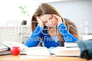 Young girl studing in living room