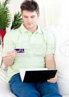 Good-looking man sitting in front of his laptop