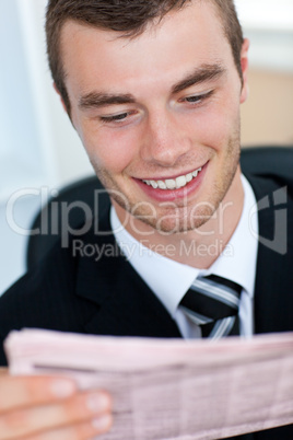 Young businessman reading newspaper