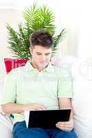 Charming man sitting in front of his laptop
