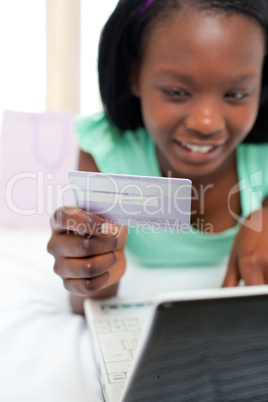 Pretty woman using a laptop sitting on bed