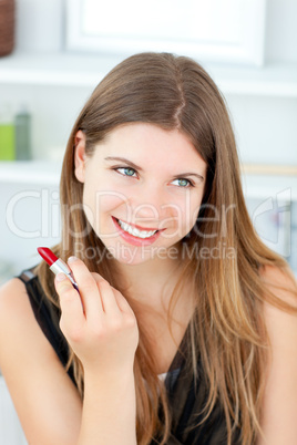 Beautiful girl using lipstick