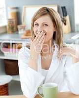 Yawning woman with a cup