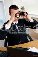 Businessman using binoculars