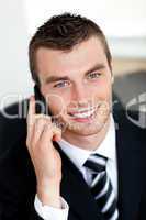 Smiling businessman using mobile phone