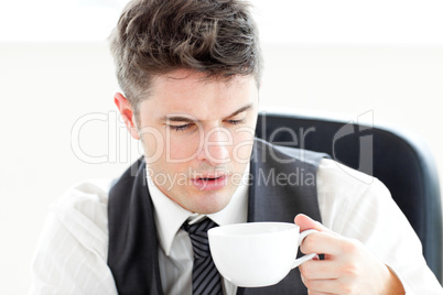 Tired businessman drinking coffee