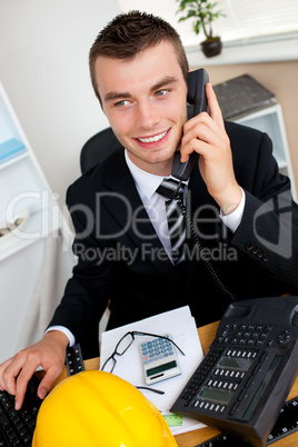 Charming businessman using phone