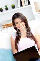 Smiling woman using laptop