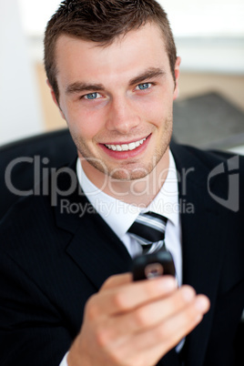 Young businessman holding mobile phone