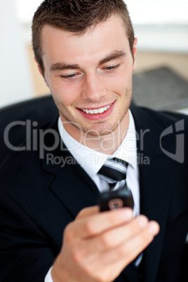 Handsome businessman holding mobile phone