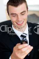 Handsome businessman holding mobile phone