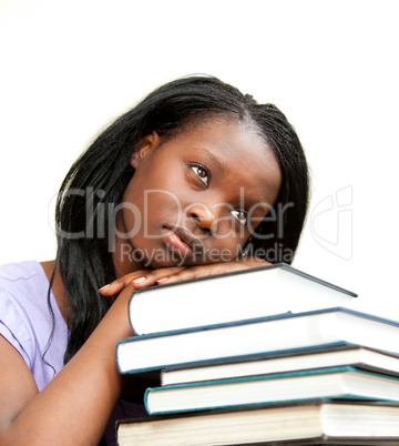 Student leaning on a stack of books
