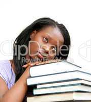 Student leaning on a stack of books