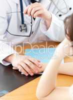 Attractive doctor holding hand of patient