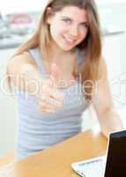 Pretty woman sitting in front of her laptop