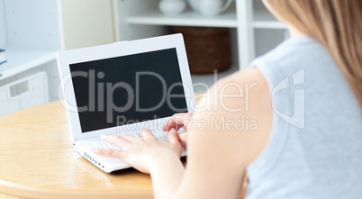 Sweet woman sitting in front of her laptop
