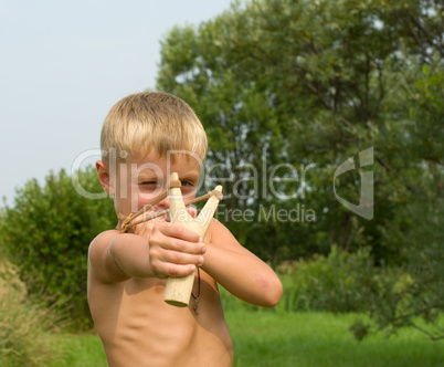 Child with a slingshot.